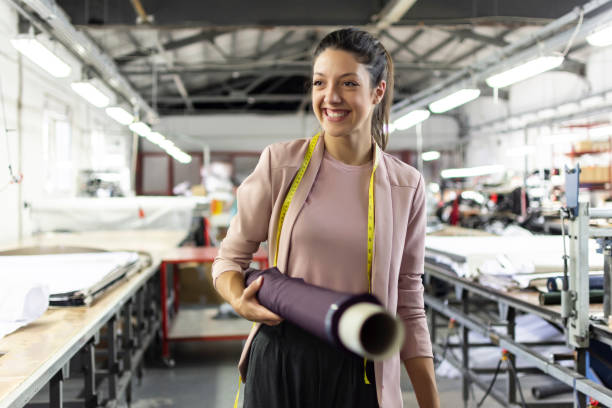 Smiling young woman working in a fashion factory